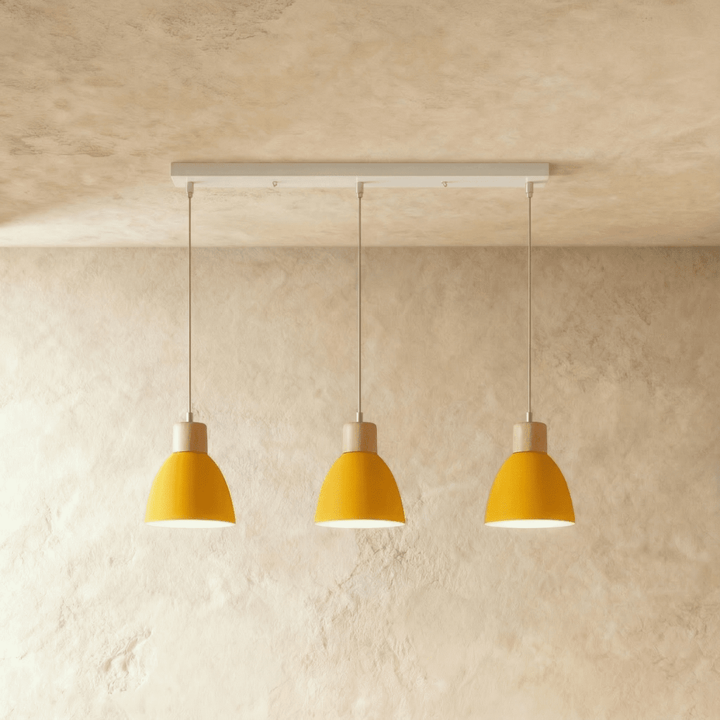 Angled view of the Clérachic three-head yellow wood disc pendant light row hanging from its linear ceiling bar.