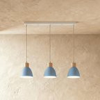 Closer view of the Clérachic three-head blue wood disc pendant light row on its slim linear ceiling bar.