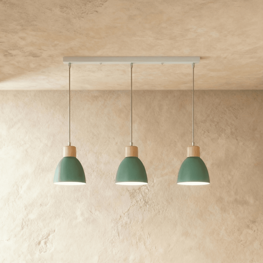 Angled view of the Clérachic three-head green wood disc pendant light row hanging from its linear ceiling bar.