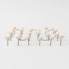 Clérachic solar mushroom stake lights, a cluster of cream glass mushroom caps on dark stems, linked by a woven cord, glowing warm white.