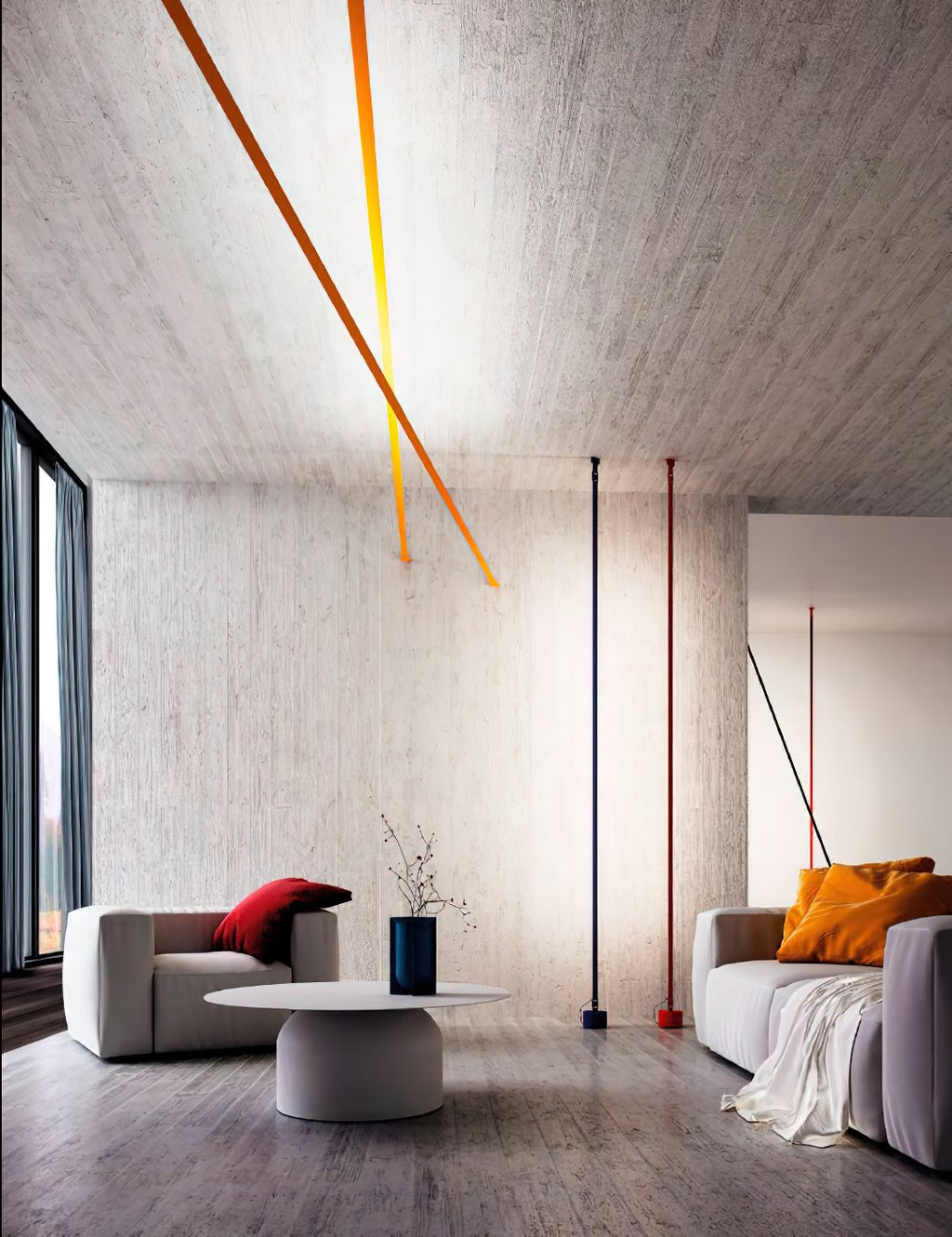 Lit ochre strips of this Clérachic floor lamp angle across a concrete ceiling above a living room with a blue vase and a grey sofa.