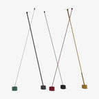 Render of Clérachic floor lamp strips of different widths on a white backdrop, with bases in green, black, red and gold.