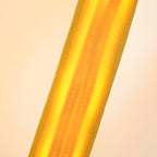 Close view of a lit yellow webbing strip on a Clérachic floor lamp, the warm light glowing through the woven fabric.