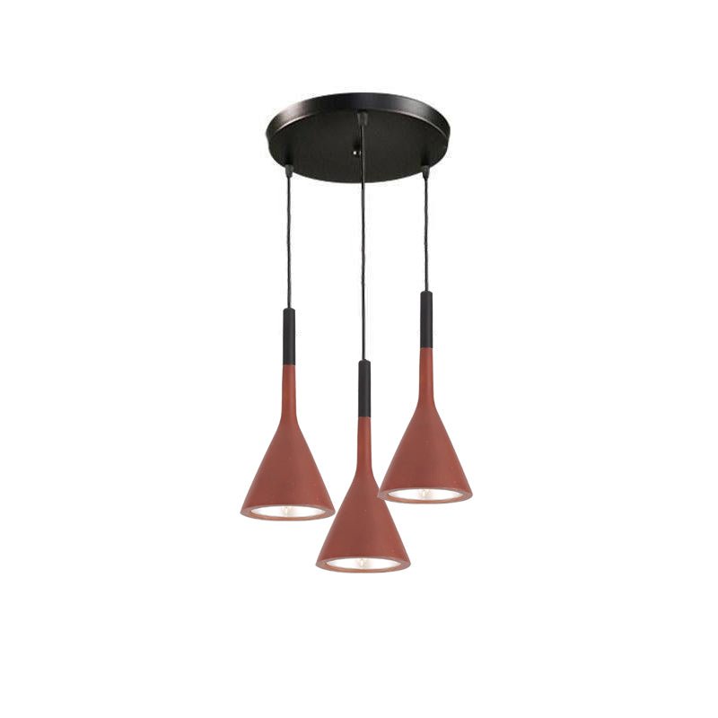 Three red-brown Clérachic cone pendants hung from a round black canopy, with a glimpse of the gold-toned inner shade in each.