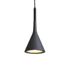 Close view of a black Clérachic cone pendant with a gold-toned inner shade and small pores in the surface, on white.