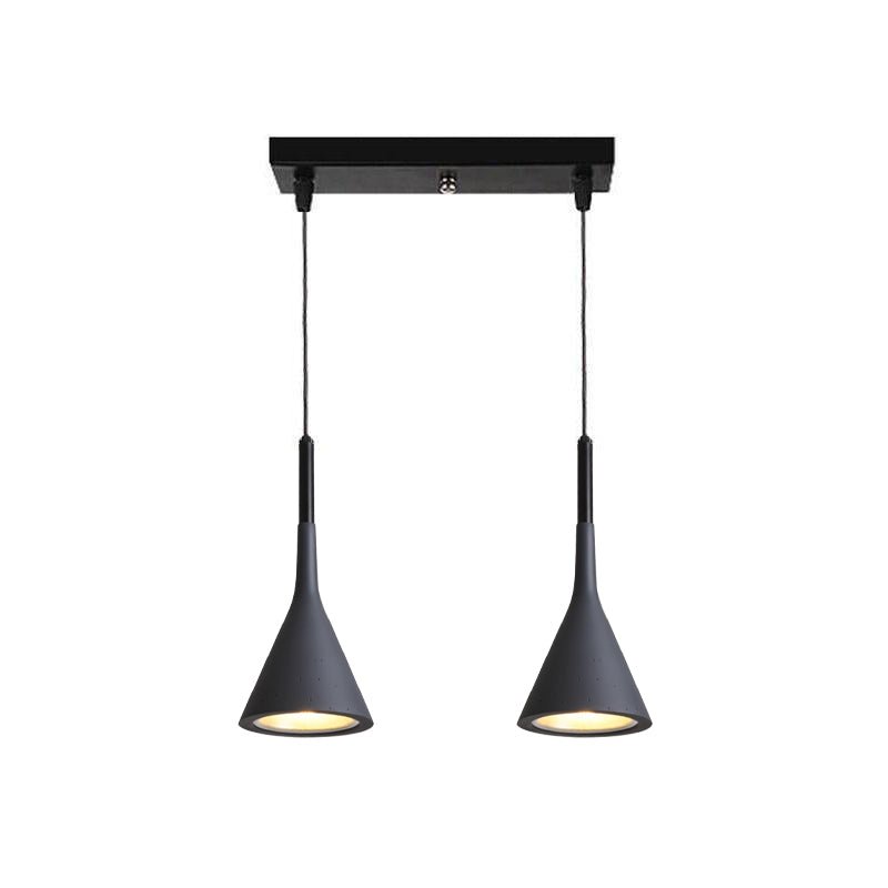 Two black Clérachic cone pendants hung from a short black bar, one slightly lower than the other, on a white backdrop.