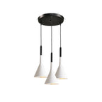 Three white Clérachic cone pendants on a round black canopy, hung at staggered heights on a plain white backdrop.