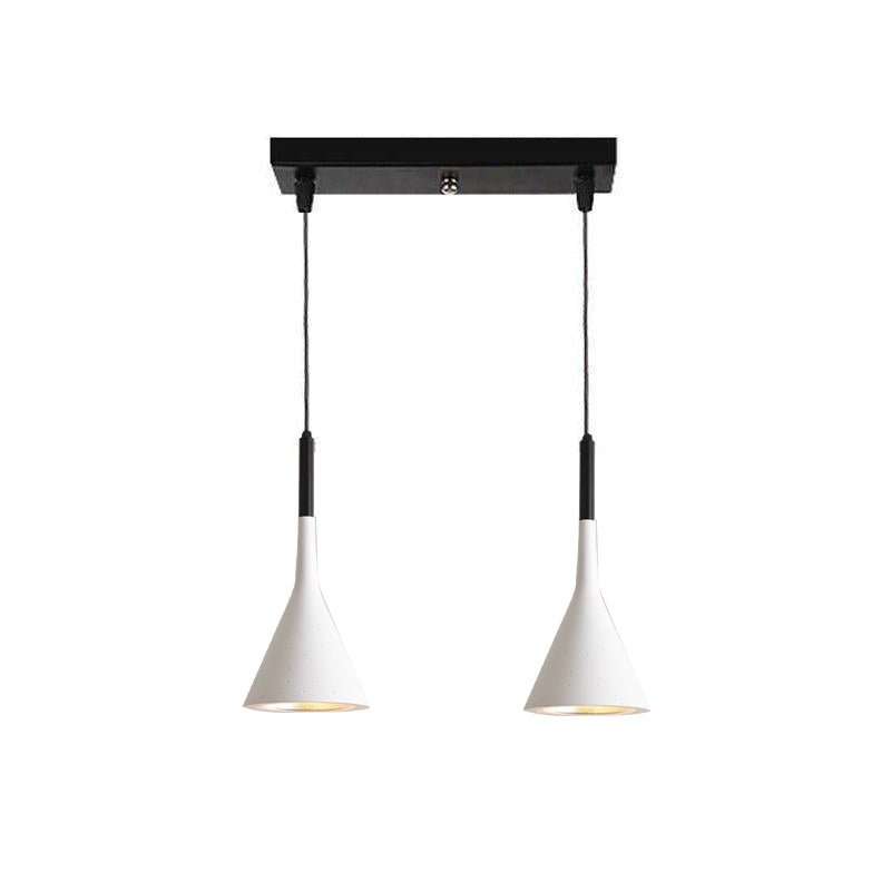 Two white Clérachic cone pendants on a short black bar, with black cord sleeves and pale inner shades, on a white backdrop.