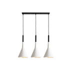 Three white Clérachic cone pendants hung from a long black bar, with black cord sleeves and light inner shades, on white.