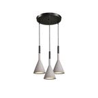 Three concrete grey Clérachic cone pendants hung from a round black canopy at different heights, on a white backdrop.