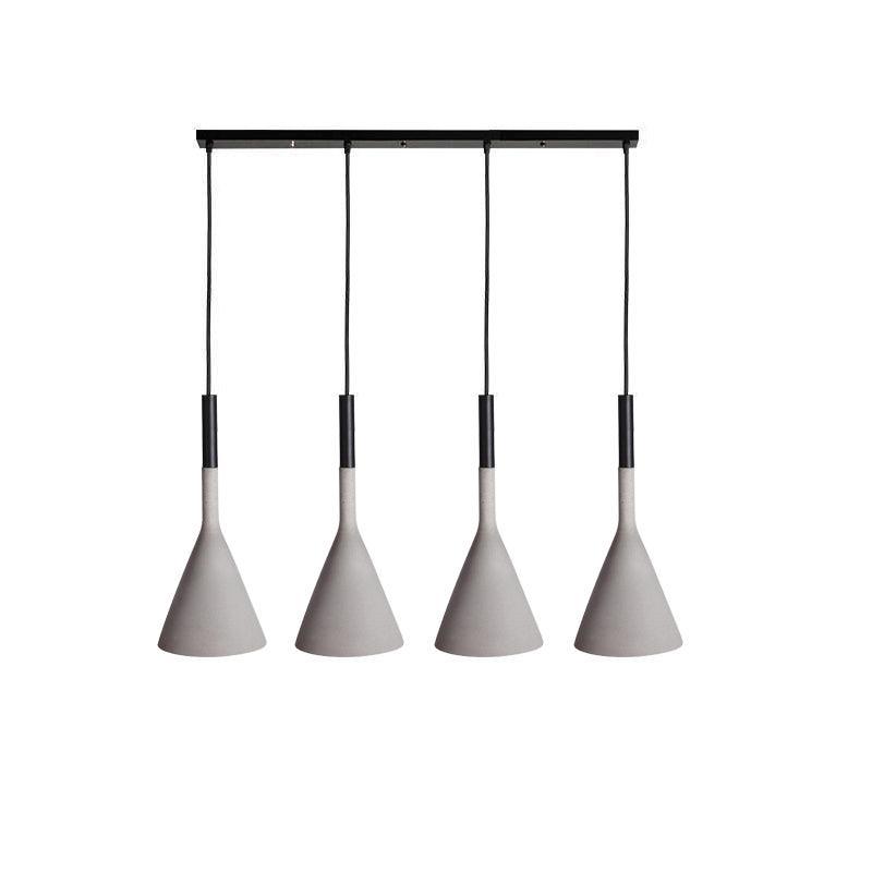 Four concrete grey Clérachic cone pendants in a row on a long black bar, each with a black cord sleeve, on a white backdrop.