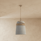 Clérachic grey concrete bucket pendant with natural hemp rope wrapped around its top and a twisted rope drop from the ceiling.