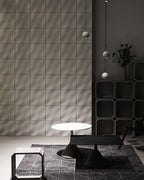 Three Clérachic spheres hang at different heights beside a tiled wall and shelving, above low black tables.