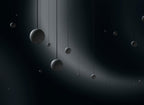 A scatter of Clérachic concrete spheres of many sizes hangs on fine cords in a dark space, lit by a sweeping beam.