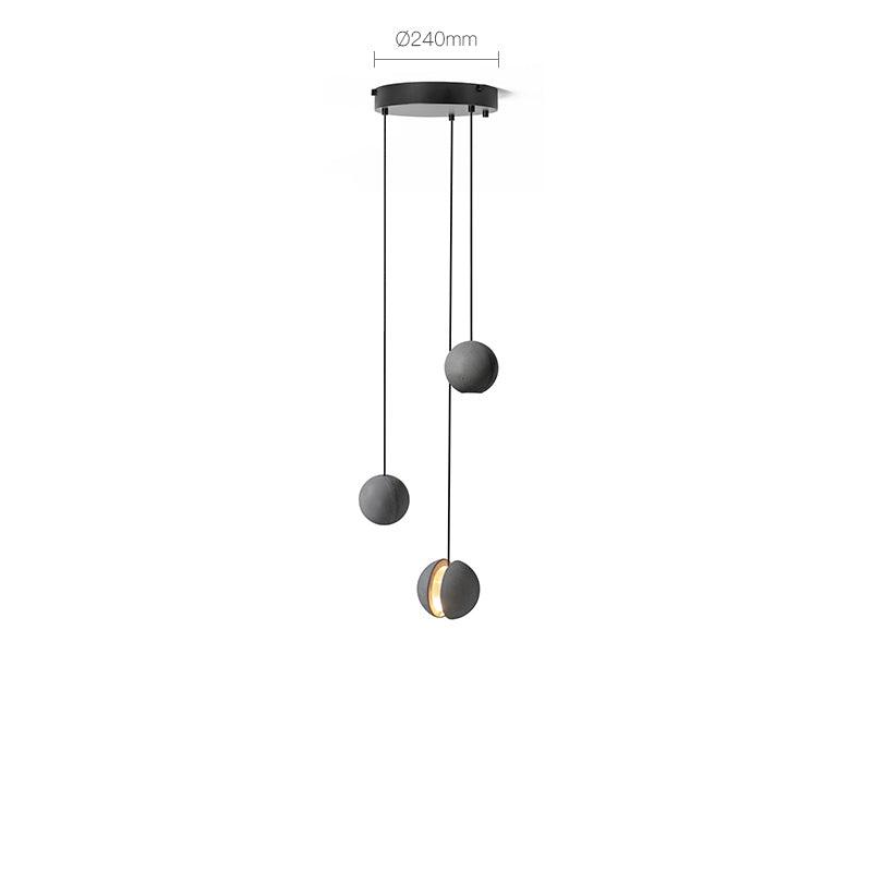 Product view of three Clérachic pendants on a round black ceiling plate, the plate width marked above, one lit.