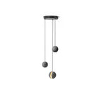 Three Clérachic pendants hang from a round black canopy on white, the lowest showing a glowing slot.