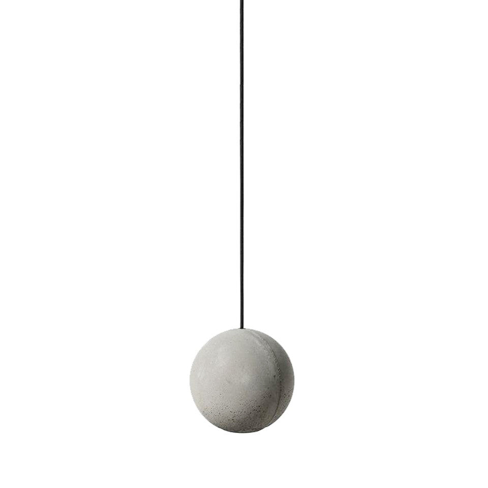 A single smooth cement-grey Clérachic sphere pendant on a long black cord against white.