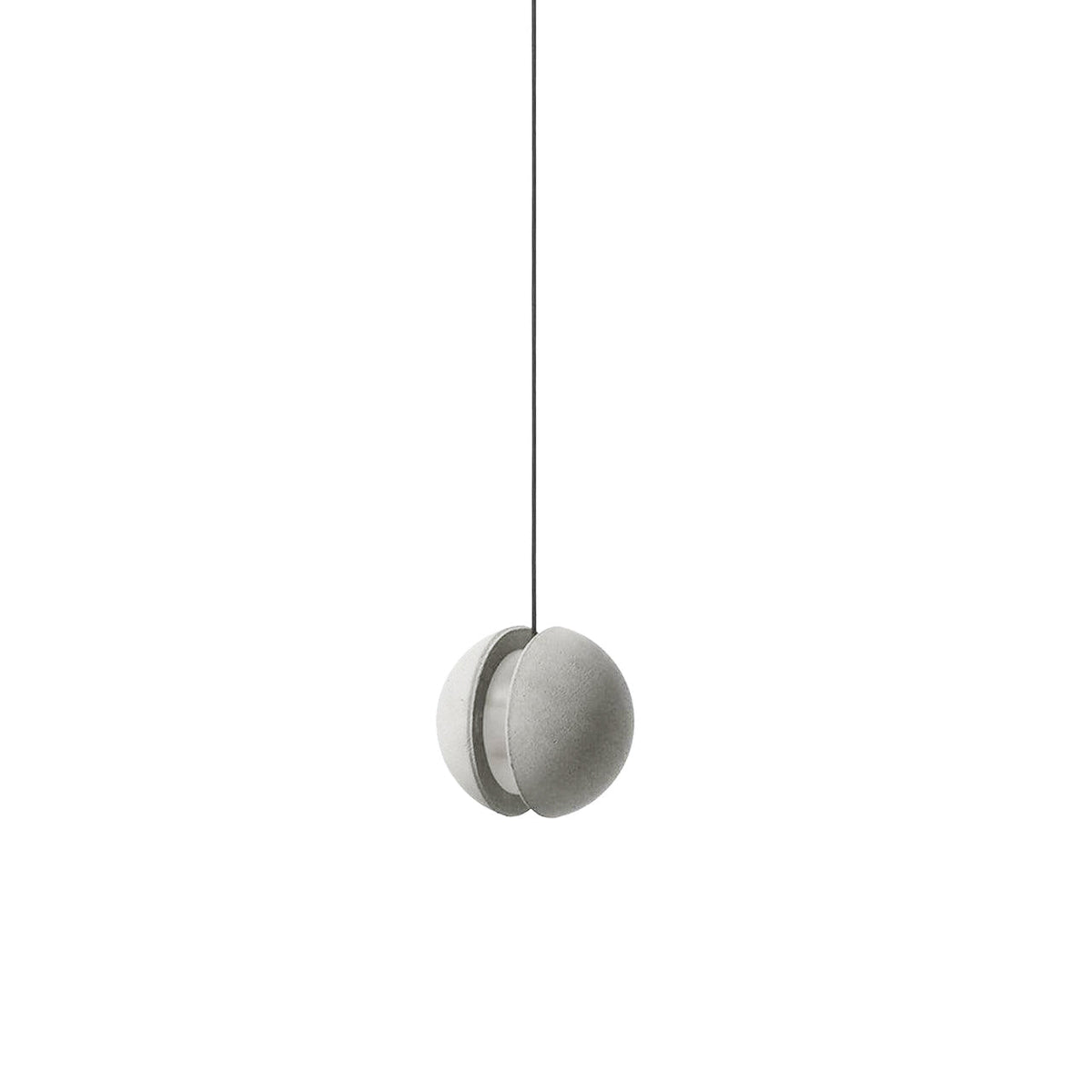 A pale Clérachic concrete pendant with a split shell hangs on a thin black cord against white, unlit.