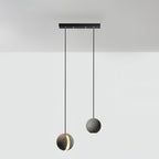 Two Clérachic concrete pendants hang from a short black bar canopy, the lower one glowing through its slot.