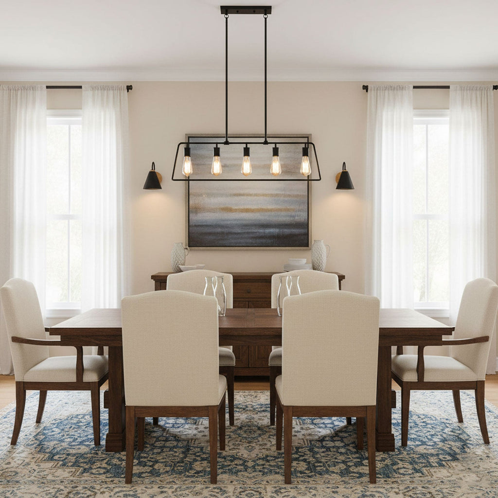 Two black Clérachic wall lights frame a landscape painting above a wooden dining table with cream chairs and a lantern-style pendant.