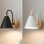Side-by-side views of this Clérachic wall light in black on the left and white on the right, each with a wooden backplate and a soft glow.