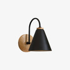 Black cone-shaded Clérachic wall light on a curved stem, shot on a pale studio backdrop with a wooden backplate.