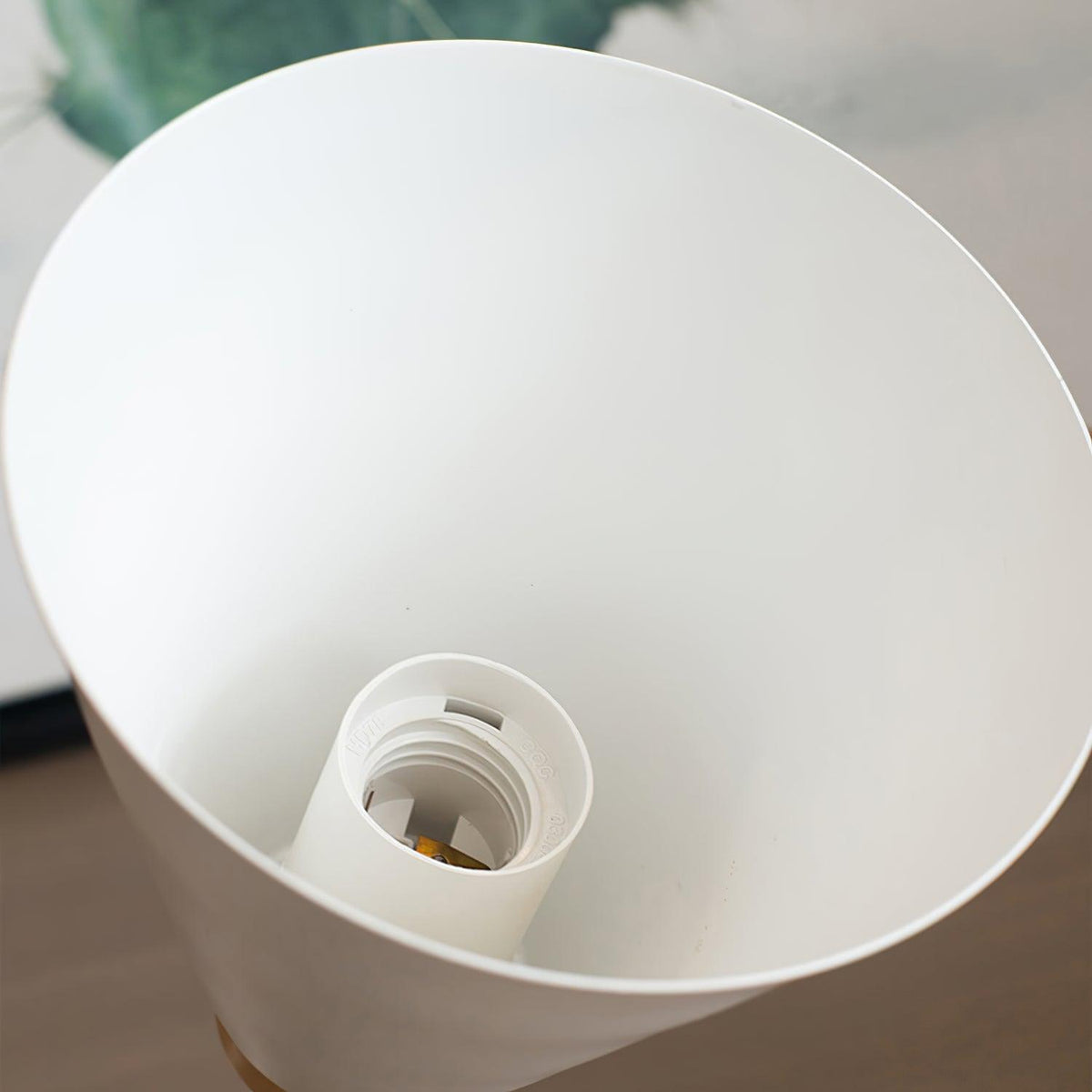 Looking up into the white inside of this Clérachic wall light's shade, showing the lamp holder at the centre.