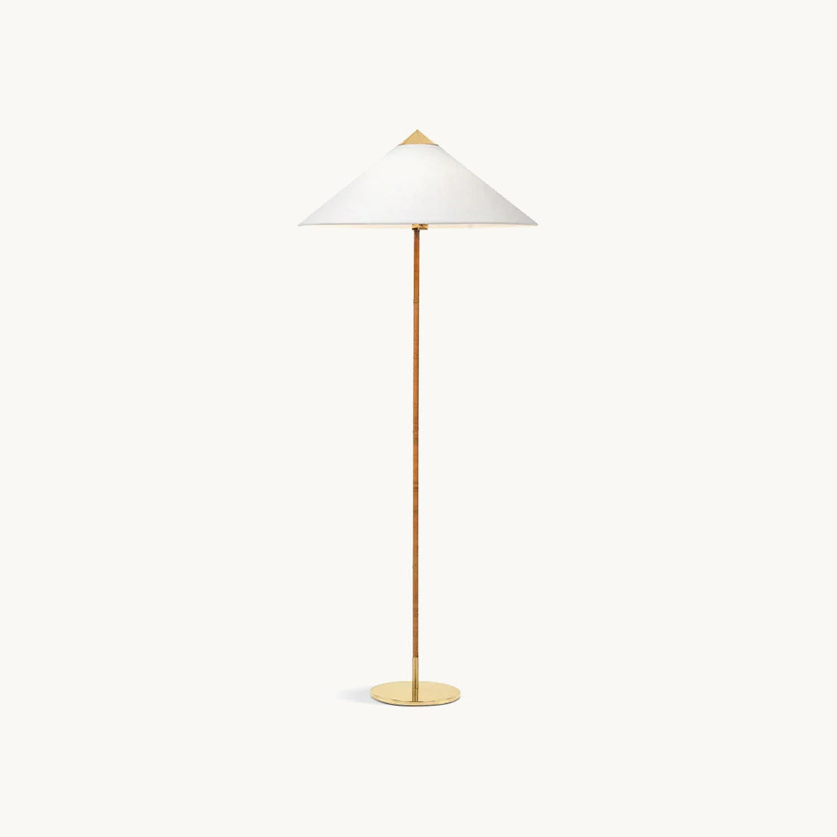 Clérachic floor lamp with a wide white fabric cone shade on a slim wrapped stem and round brass base, on a plain off-white backdrop.