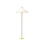 Clérachic floor lamp with a white cone shade, a rattan-wrapped stem and a thin brass base, on white.
