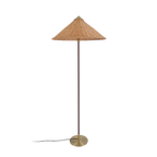 A Clérachic floor lamp with a rattan cone shade and a dark brown stem, its cord at the base, on a black backdrop.