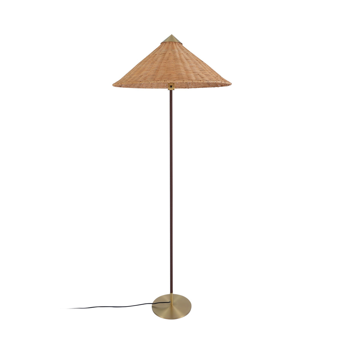 Clérachic floor lamp with a woven rattan cone shade and a thin dark stem, on a round brass base, on white.