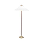 Floor lamp by Clérachic, with a white fabric cone shade, a dark stem and a brushed brass base, on white.