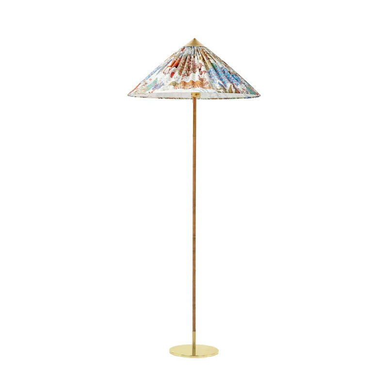 Slim-stemmed Clérachic floor lamp with a printed fabric cone shade in bold colours and a plain brass base, on white.