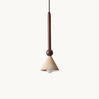 A travertine cone shade with a bare bulb hangs from a dark walnut stem and round wooden bead against a plain cream backdrop, this Clérachic pendant.