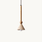 A travertine cone pendant with a bare bulb and a light wooden stem and bead hangs against a plain cream backdrop, from Clérachic.