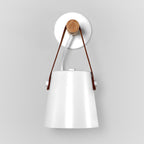 White Clérachic wall light viewed from the front, the strap rising to a wooden pin on a round white wall plate.