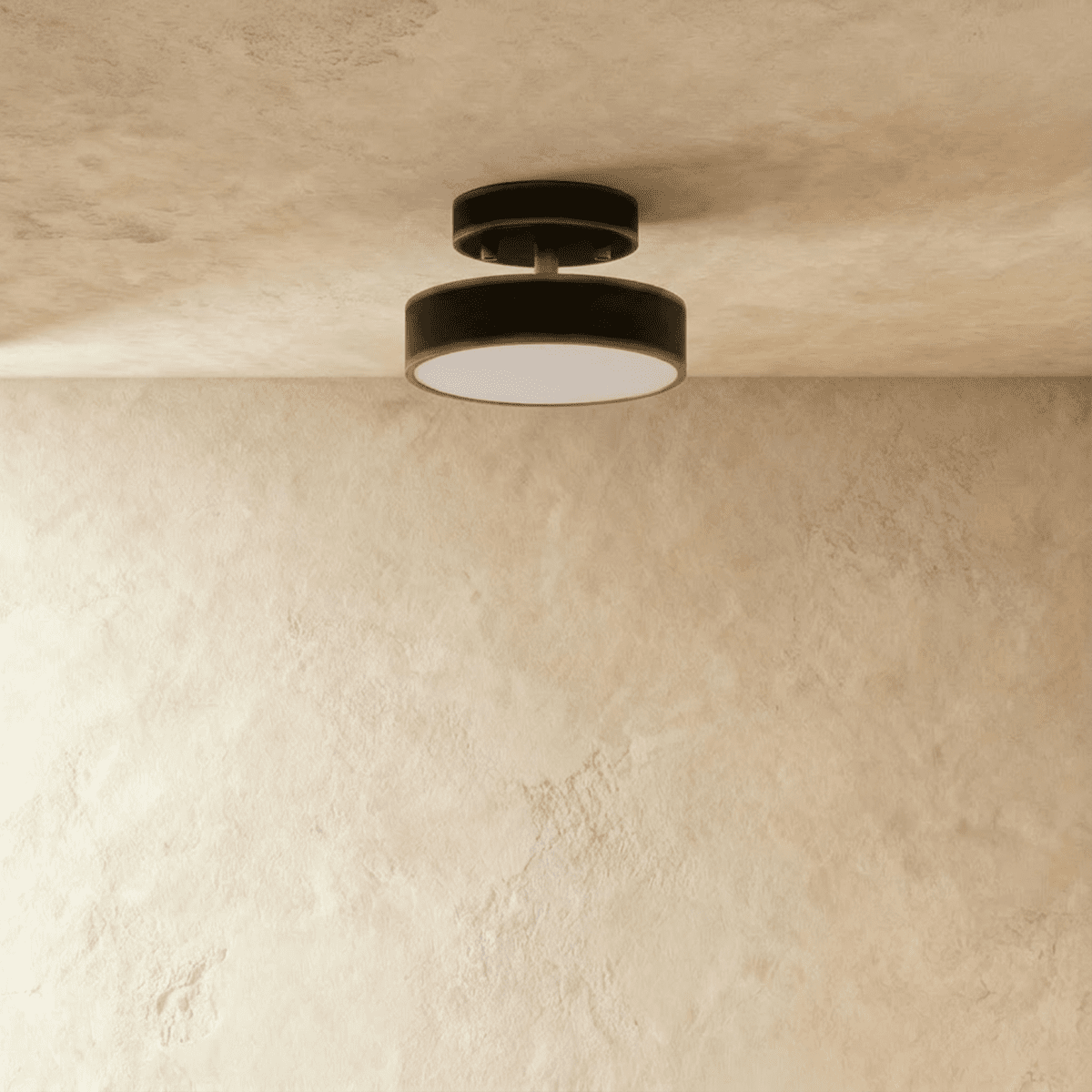 Clérachic black flush ceiling light with a round frosted lens, mounted close to a softly lit plaster ceiling corner.