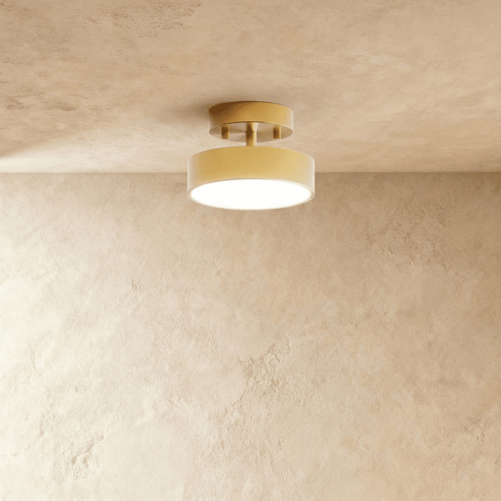 Clérachic copper-finish flush ceiling light with a warm frosted disc, mounted close against a plaster ceiling.