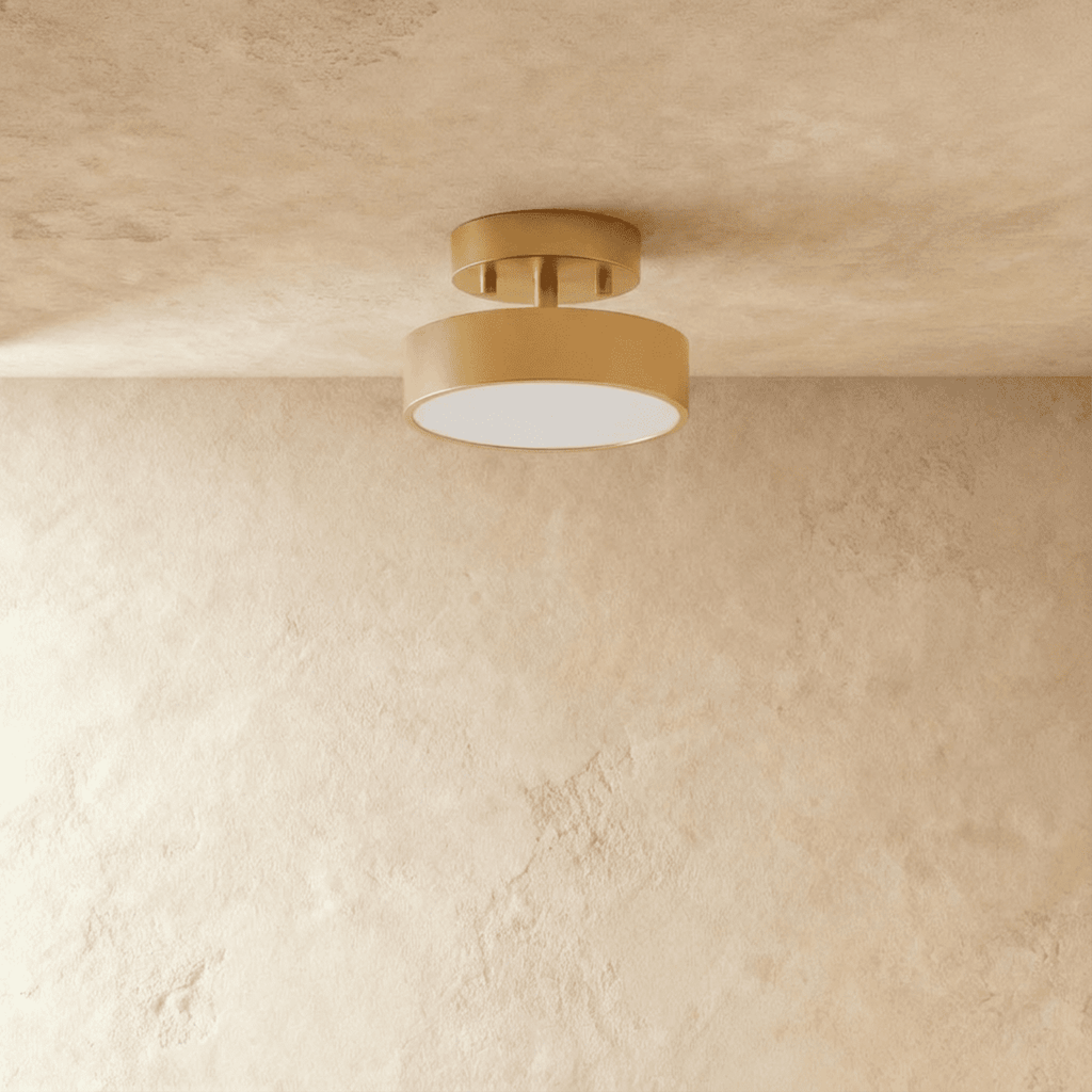 Clérachic copper-finish ceiling light with a round frosted lens, flush-mounted to a softly textured plaster ceiling.