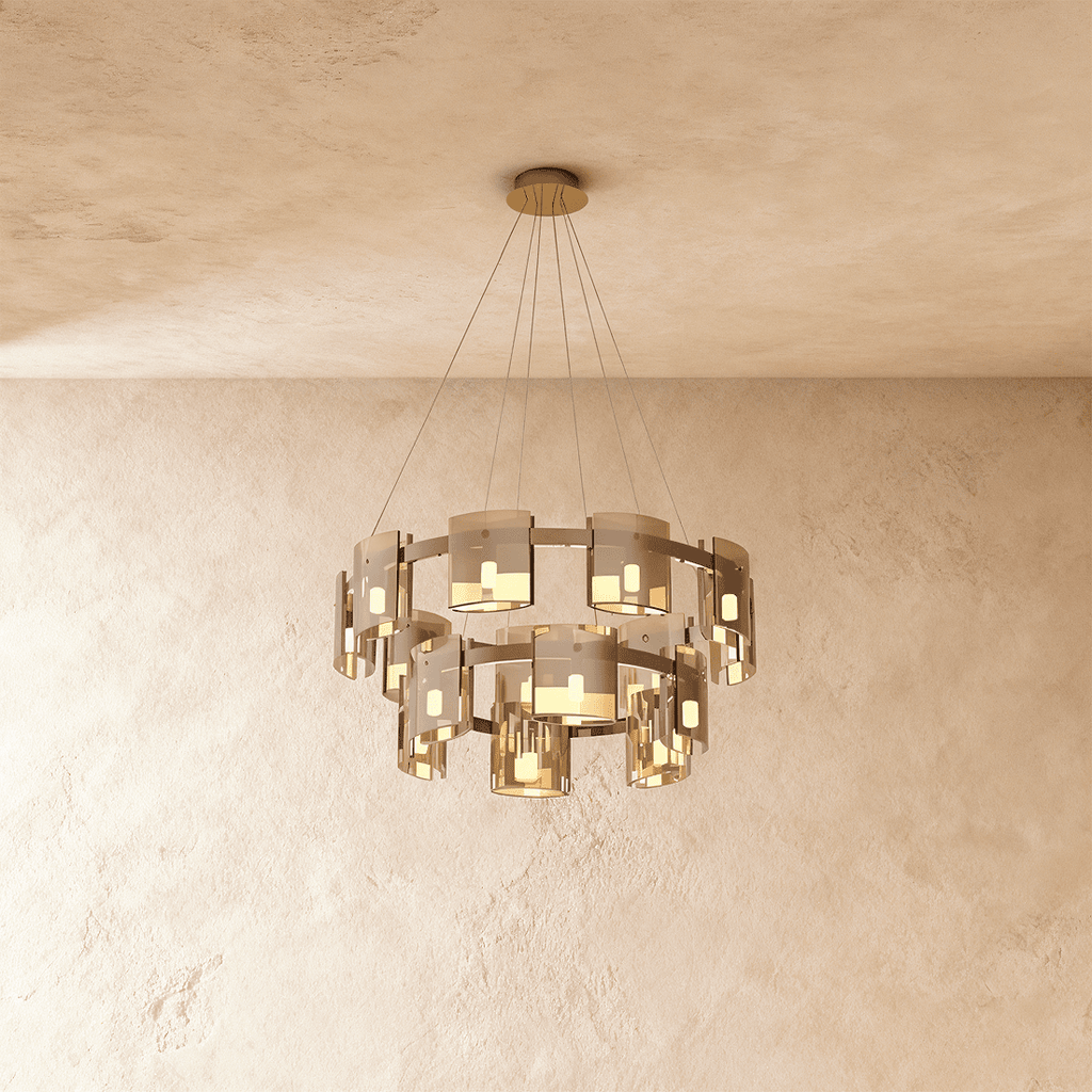 Clérachic chandelier in smoky bronze glass, its two tiers of cylinder shades lit against a plaster ceiling.