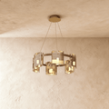 Clérachic chandelier in a single tier of amber-toned glass cylinders on slim suspension cables.