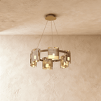 Clérachic chandelier in a single tier of amber-toned glass cylinders on slim suspension cables.