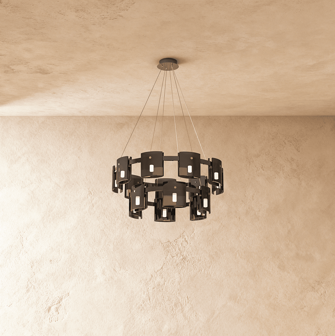 A larger two-tier Clérachic chandelier in dark smoky glass cylinders against a plaster wall.