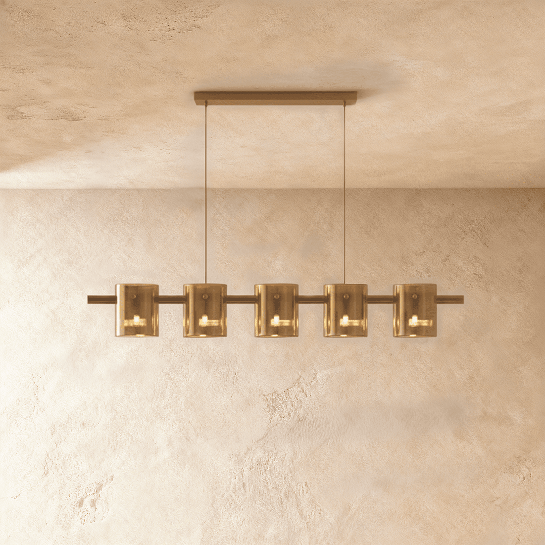 Clérachic linear chandelier with five amber glass cylinder shades along a slim bronze bar.