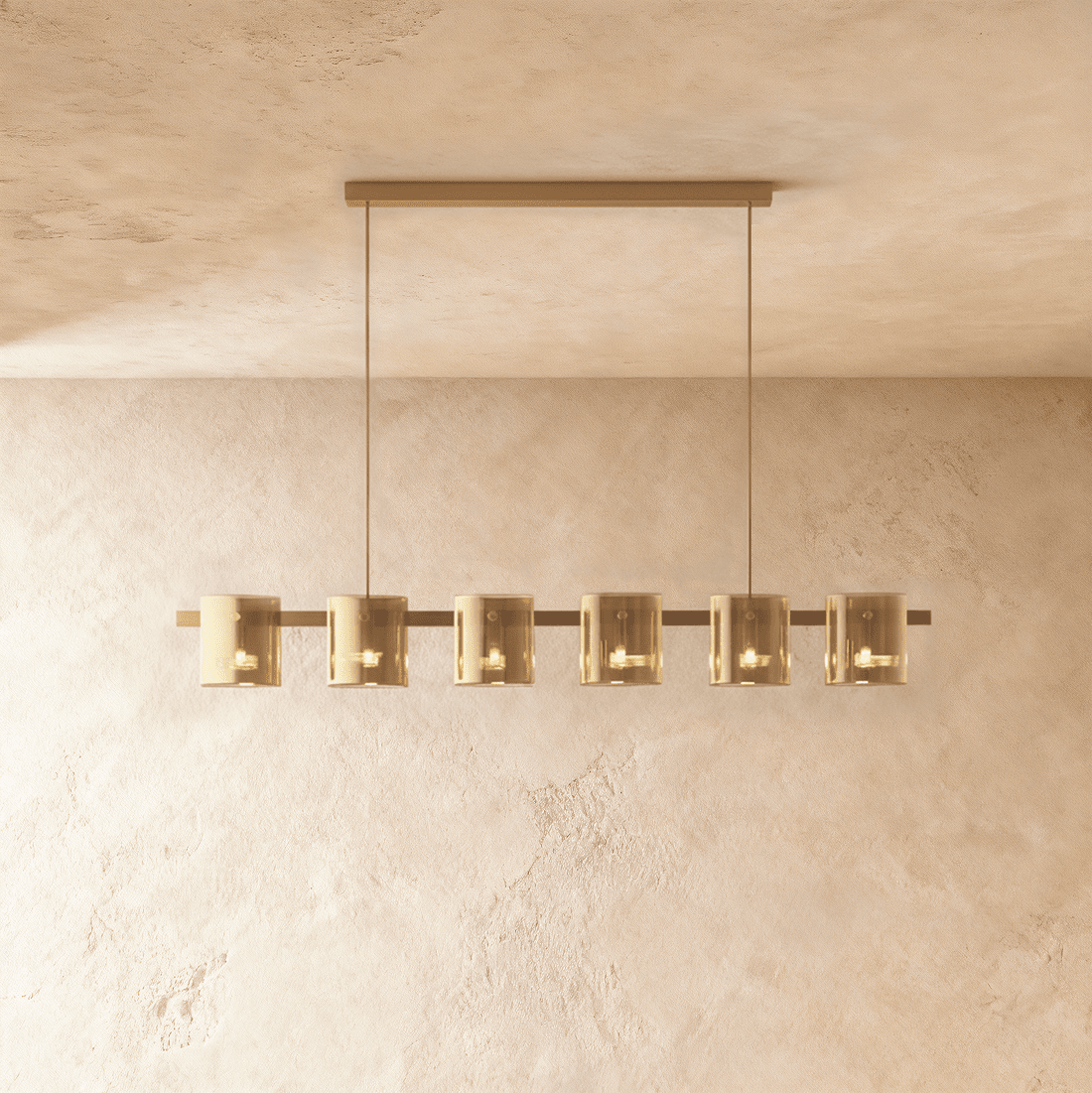 Clérachic linear chandelier with six amber glass cylinder shades along a slim bronze bar, each lit softly within.