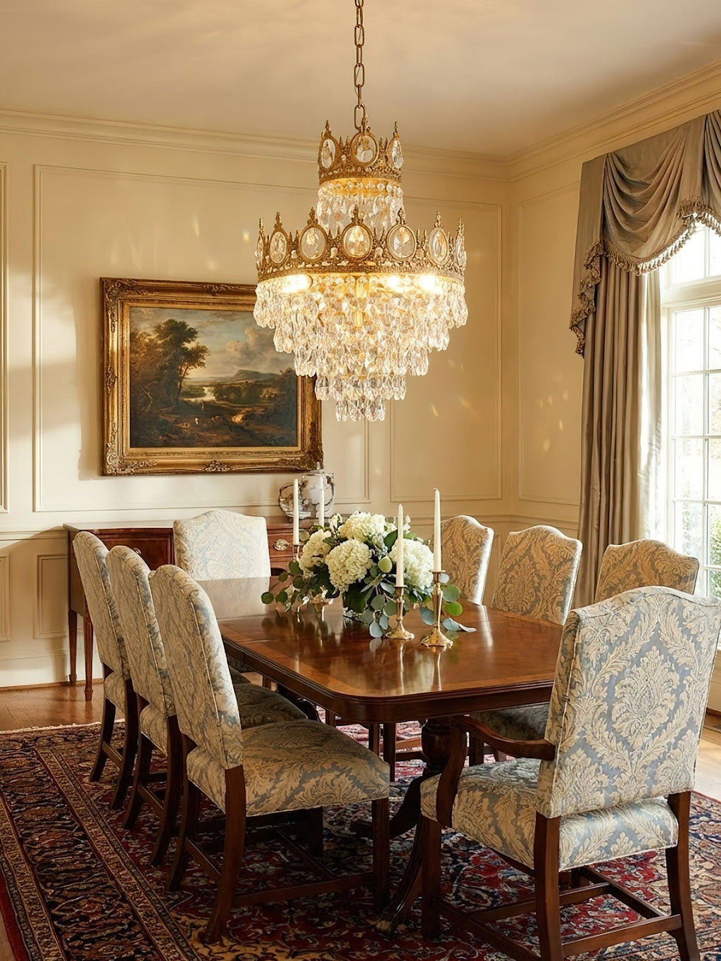 Clérachic chandelier lit above a long dining table with damask chairs, a cream room with silk drapes and a landscape painting.
