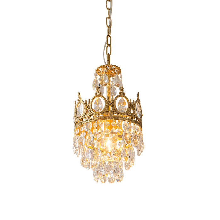 Smaller Clérachic chandelier lit on a white background, with a single crown ring and a skirt of clear crystal drops.