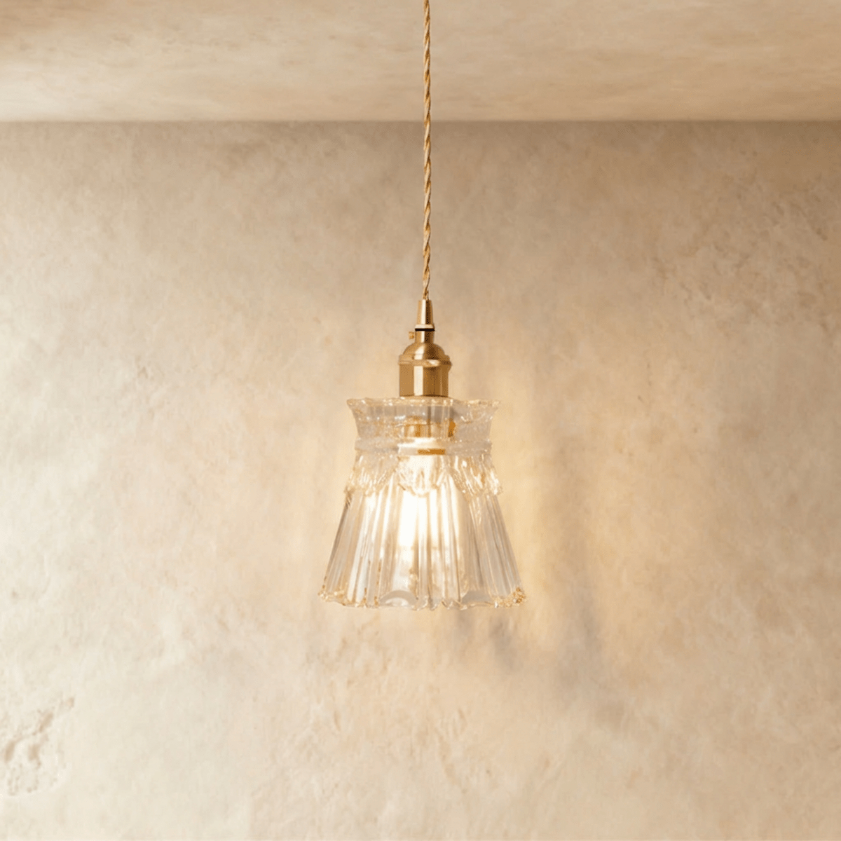 Clérachic Isabel pendant light, a ruffled clear glass flower shade with a scalloped edge and an exposed teardrop bulb.