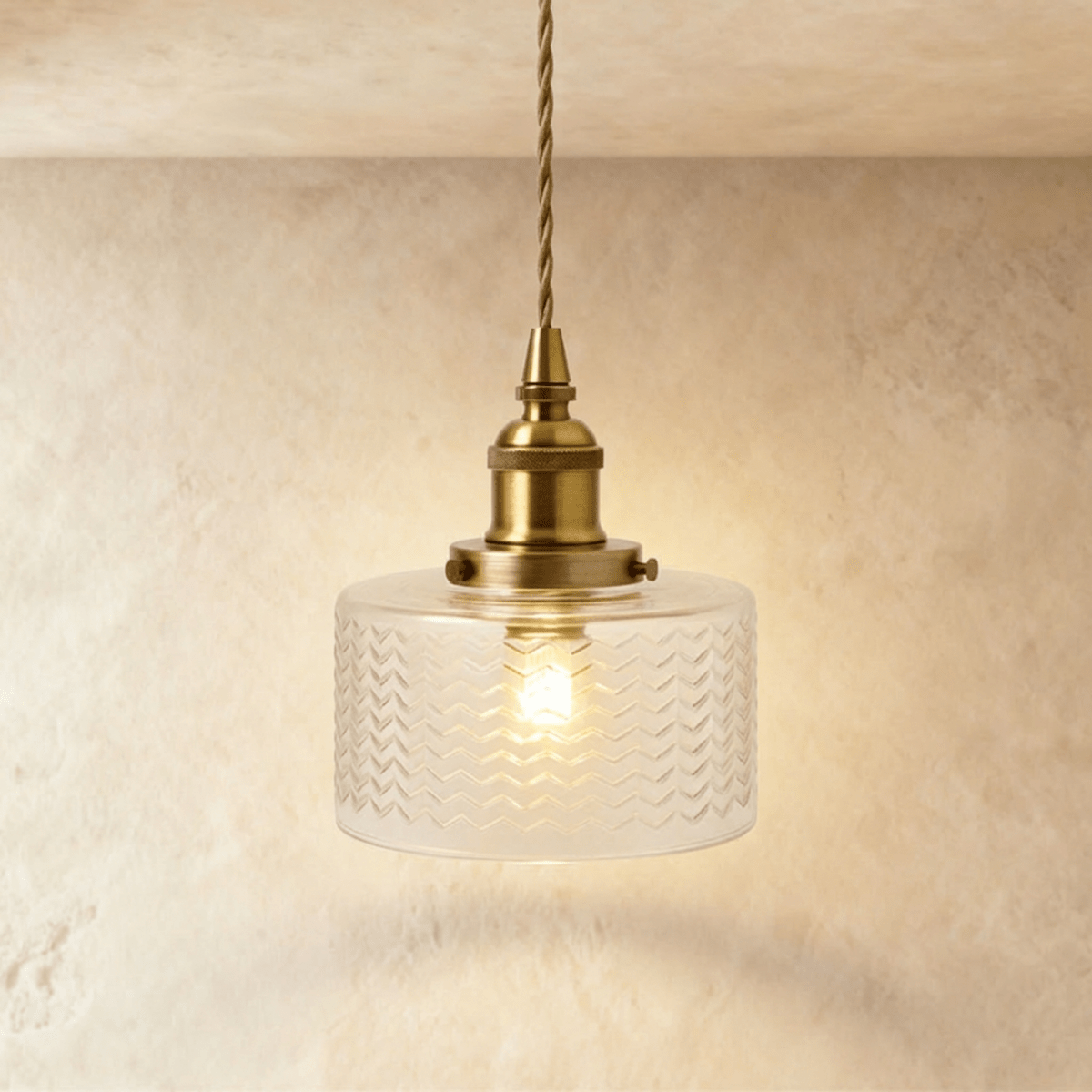 Clérachic Isabel pendant light, a compact clear glass drum shade with a fine chevron pattern on a brass fitting.