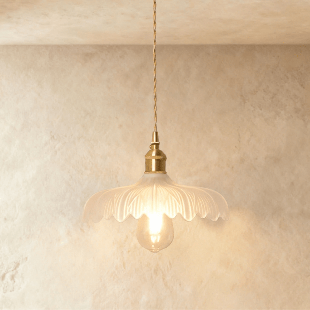 Clérachic Isabel pendant light, a ruffled clear glass flower shade with pointed scalloped petals and an exposed bulb.